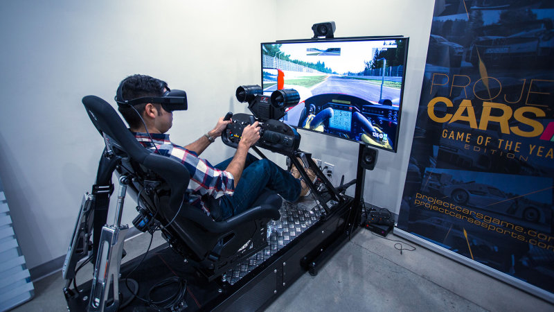 A car sim with a steering wheel and pedal setup.